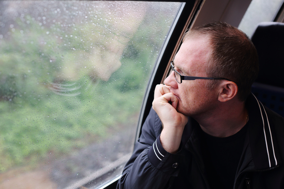 40 years old man looking to the window